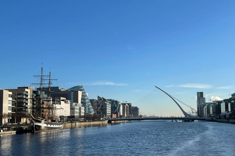 View of the Jeanie Johnston ship and the Samuel Beckett Bridge along the River Liffey in Dublin Docklands on a bright day