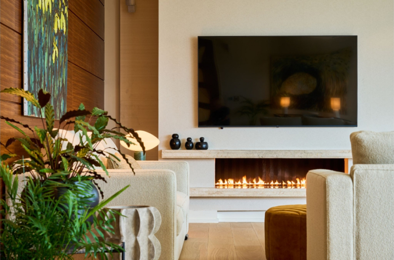 Cosy lounge area with modern decor, featuring a fireplace and flat-screen TV, part of Aghadoe Heights' recent refurbishment.