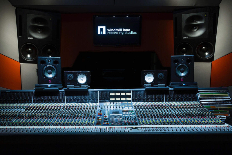 A close-up shot of a large recording console at Windmill Lane Recording Studios, Dublin, with speakers and sound equipment in the background